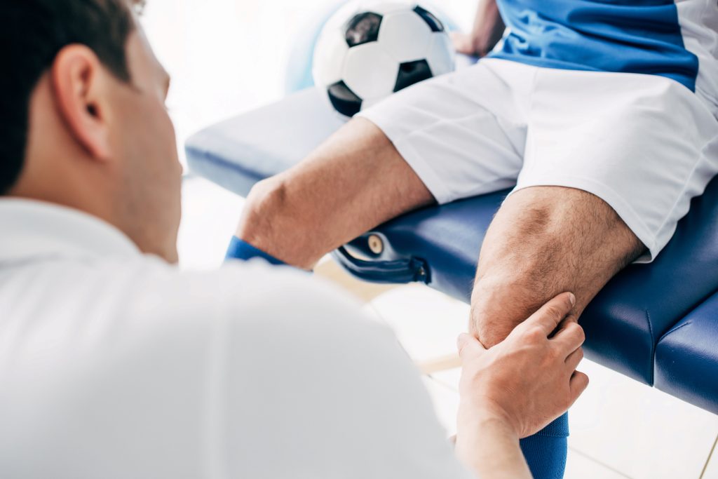 Sports Medicine Doctor diagnosing an injure