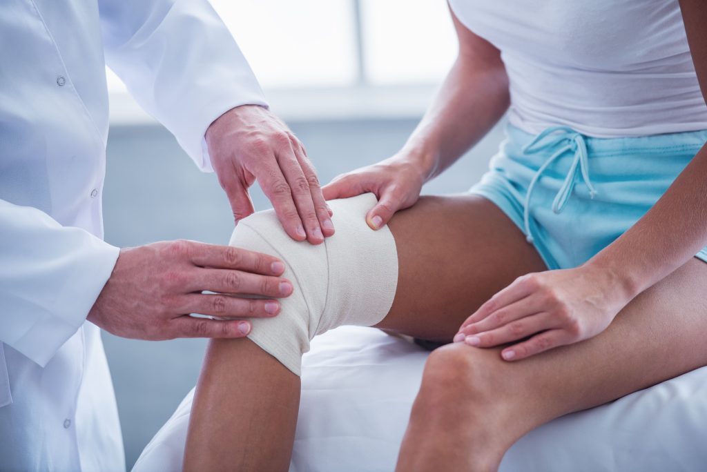 Orthopaedic surgeon performing minimally invasive arthroscopic knee surgery to treat knee pain in a Connecticut patient