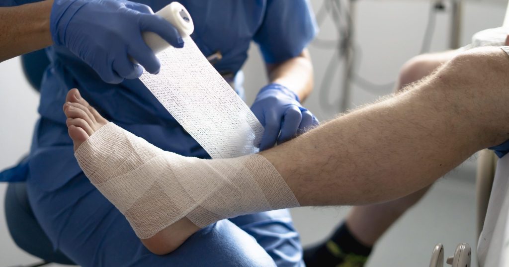 Patient receiving ankle wrap treatment at OrthoDirect walk-in orthopedic clinic in Oxford, CT for sprain or injury